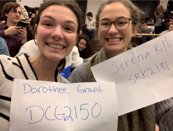 Dorothee Grant and Serena Killion in class when Professor Sethumadhavan had us take attendance with a photo of us holding up our UNI.