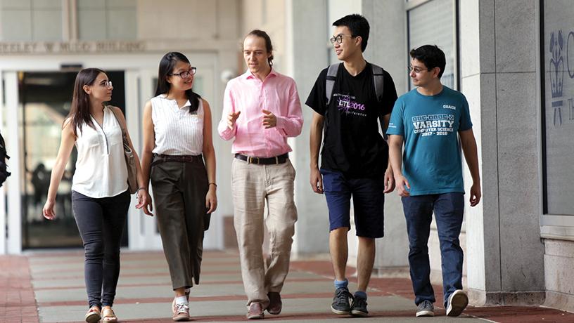 professor and students walking on campus