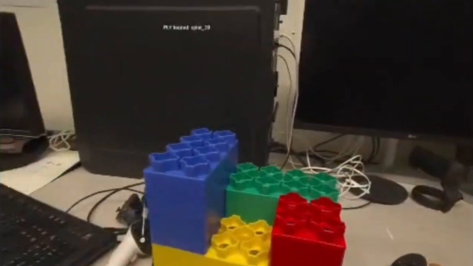 Still from the video: Lego assemblies on a desk, seen through the headset. Opens on YouTube.